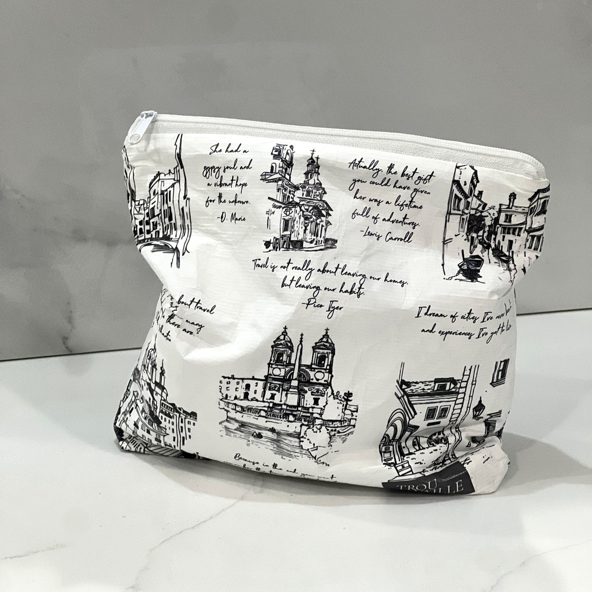 Cities Small zip pouch with hand-drawn city sketches on a white marble counter