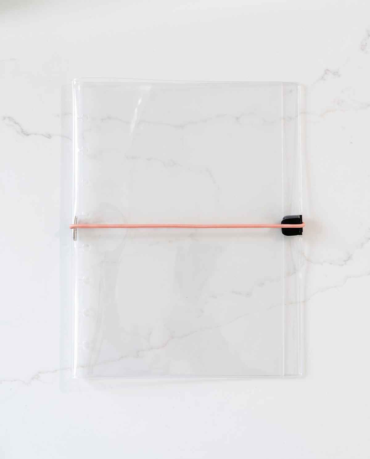 Clear half letter planner binder cover with thin coral elastic cord