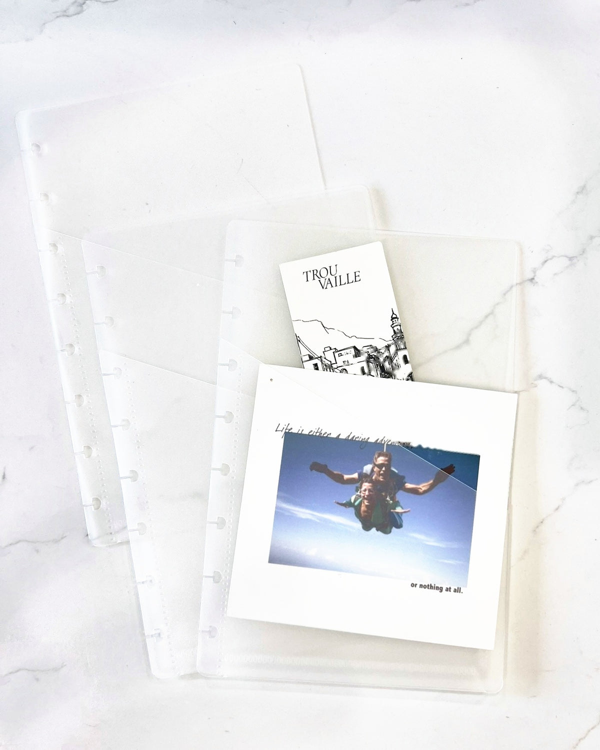 Frosted notebook pockets holding a printed photo and a Trouvaille card, half letter, punched for 8 discs