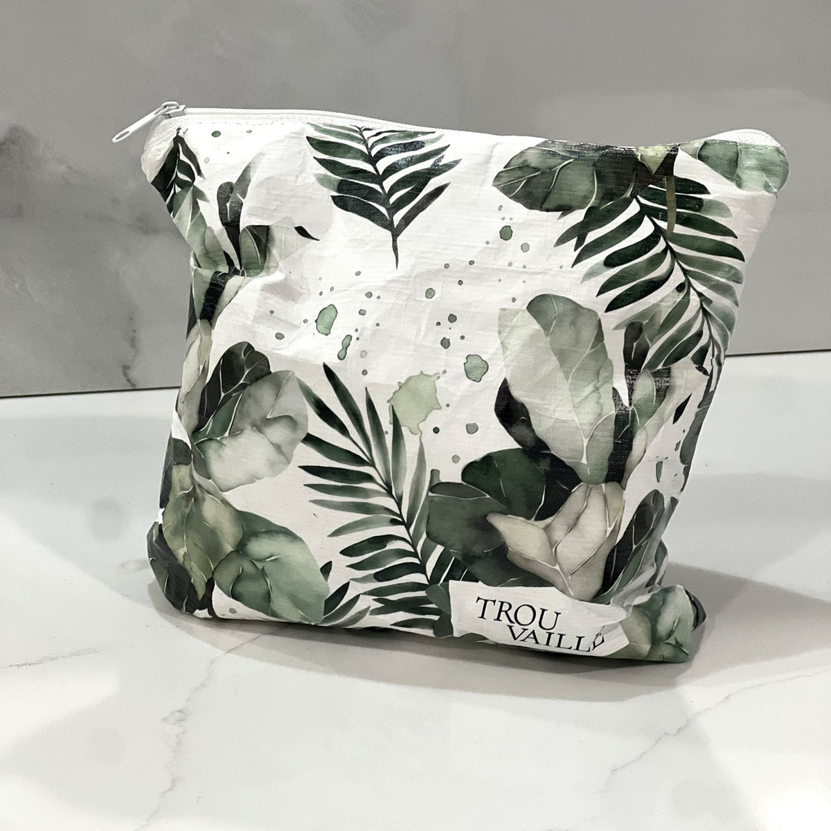 Green Leaves Small zip pouch on a white marble counter