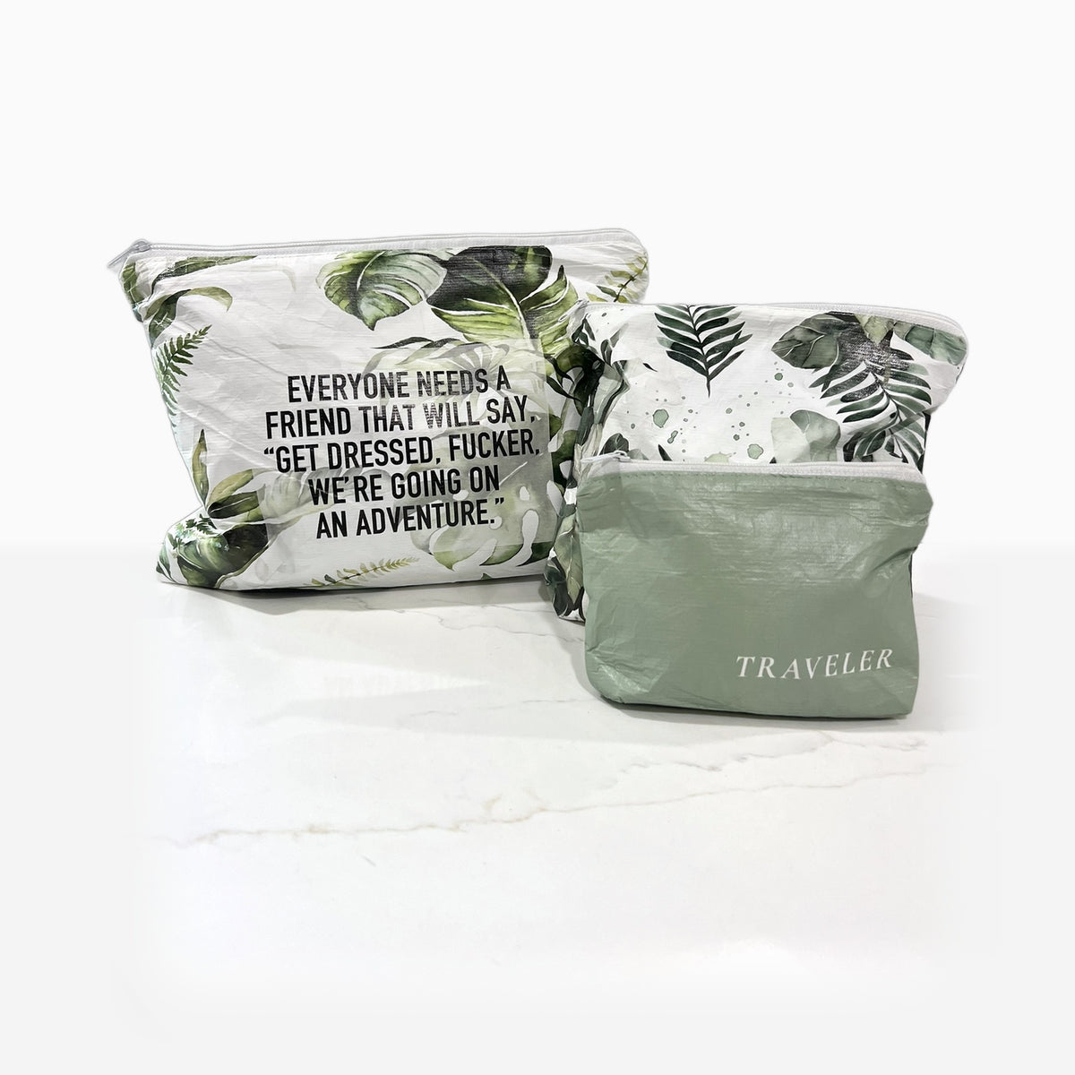 The Green Trio water-resistant zip pouches on a marble counter: Get Dressed Medium, Green Leaves Small and Sage Mini