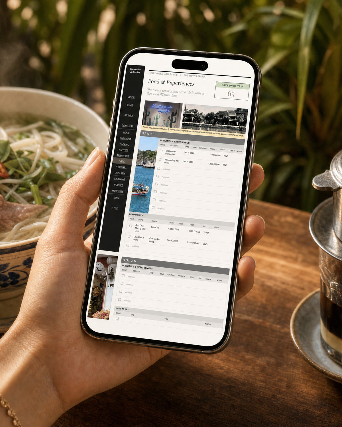 A Trouvaille digital travel planner open on a phone at a Vietnamese cafe table