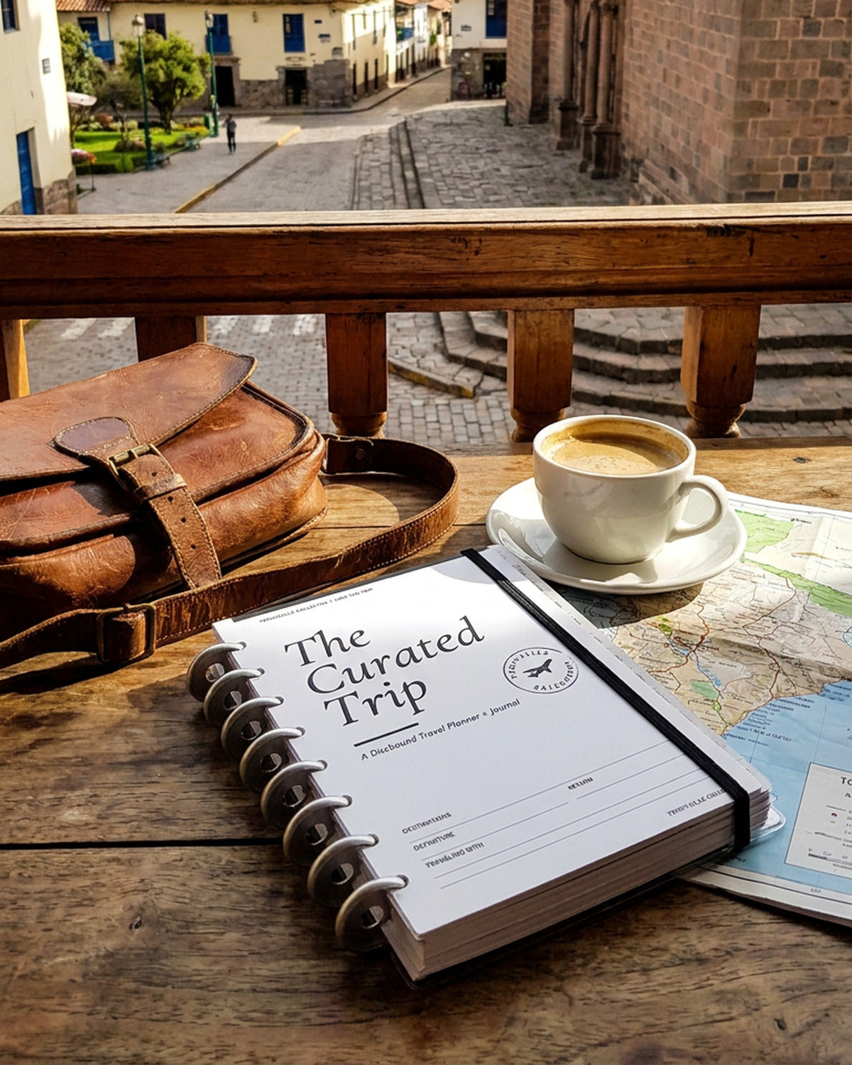 The Curated Trip discbound travel planner open on a balcony table in Peru
