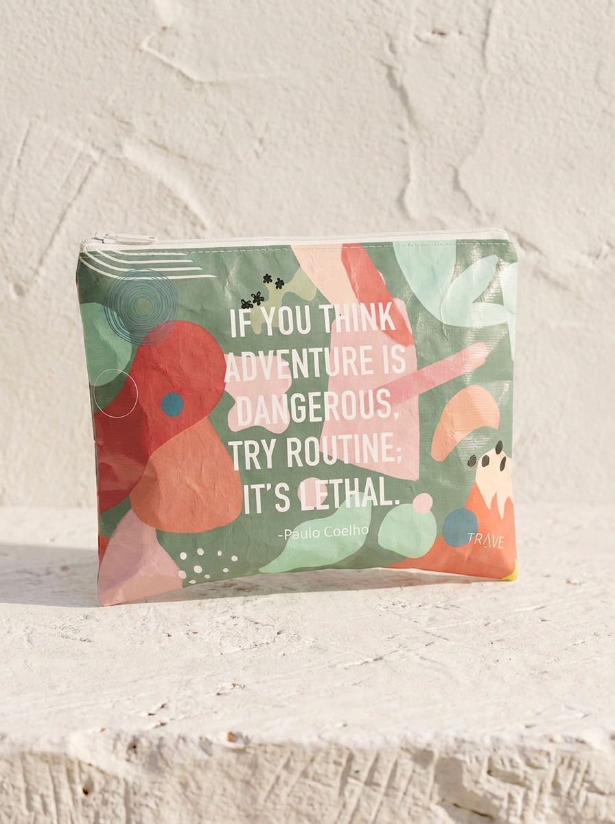 Routine is Lethal medium water-resistant accessory bag — a flat 12 x 9 inch travel pouch in an abstract collage print with a hand-lettered quote