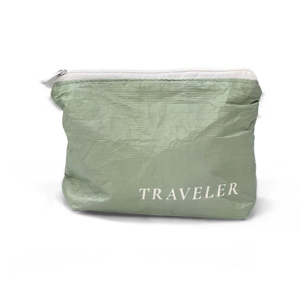 Sage green Mini water-resistant accessory bag with white zipper and TRAVELER logo