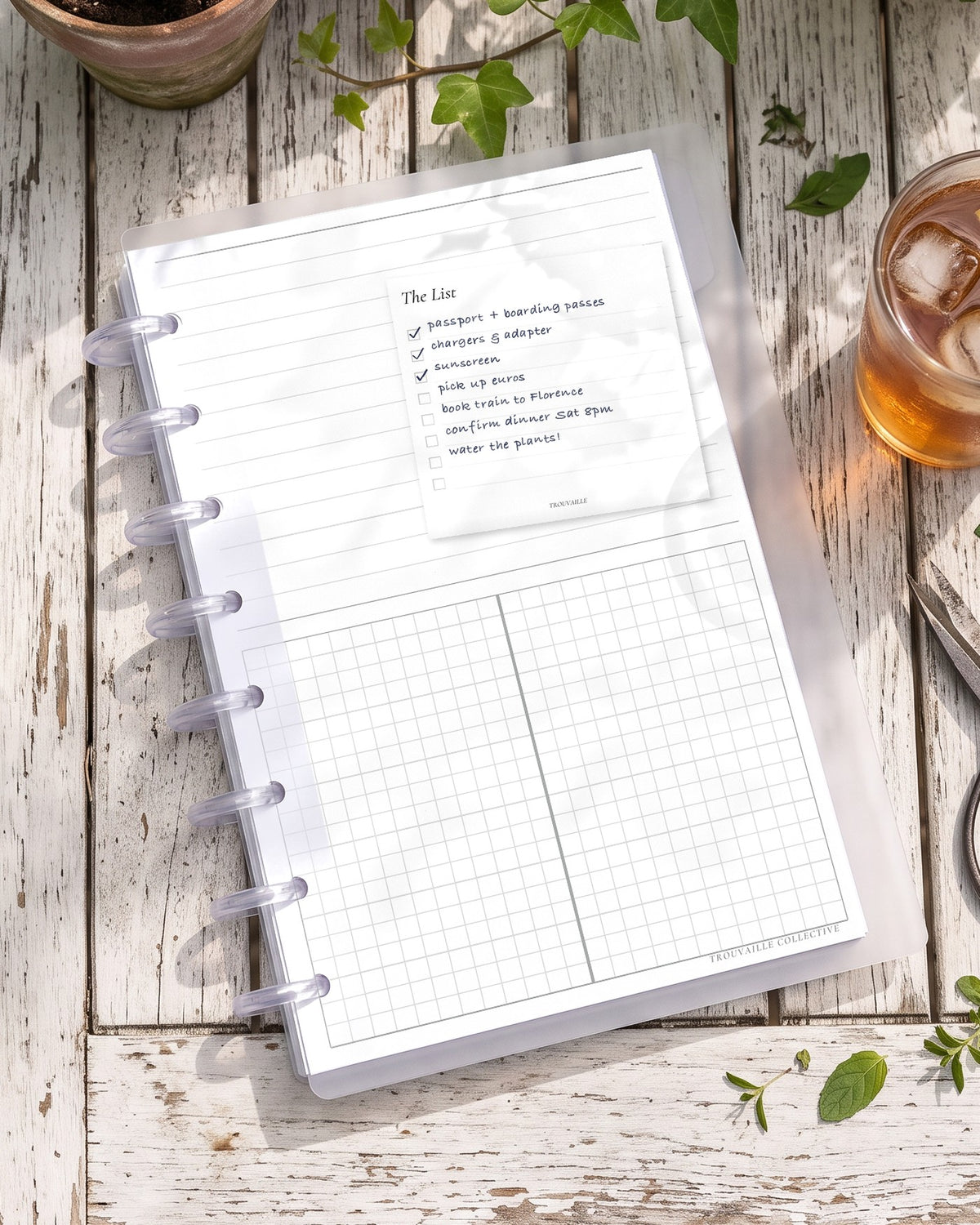 The List sticky note stuck on a planner page in a half letter discbound planner on a garden table, with handwritten notes