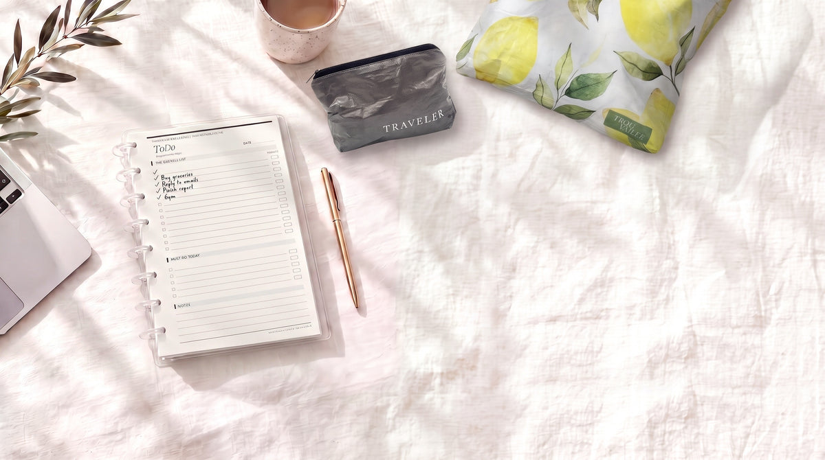 Half letter discbound planner with a handwritten To Do page beside the Ink Mini and Lovely Lemons Small water-resistant pouches on white linen