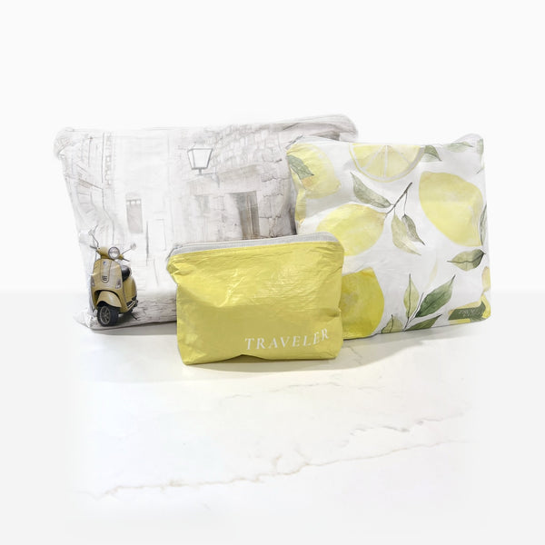 The Amalfi Trio water-resistant zip pouches on a marble counter: Italian Alley Medium, Lovely Lemons Small and Lemon Mini
