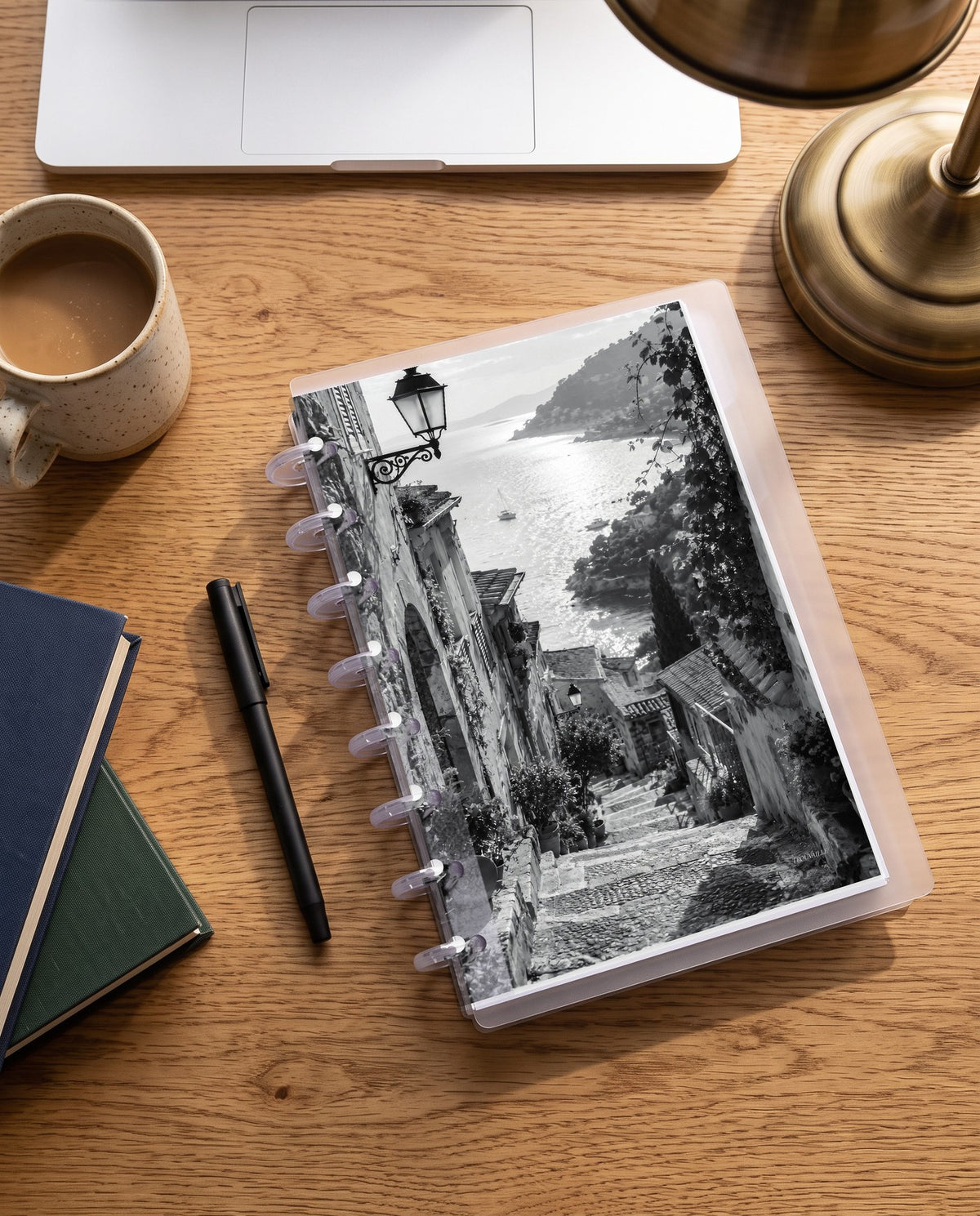 Black & White Walkway cardstock planner dashboard inside a clear half letter discbound planner with 8 discs on an oak desk with coffee and books