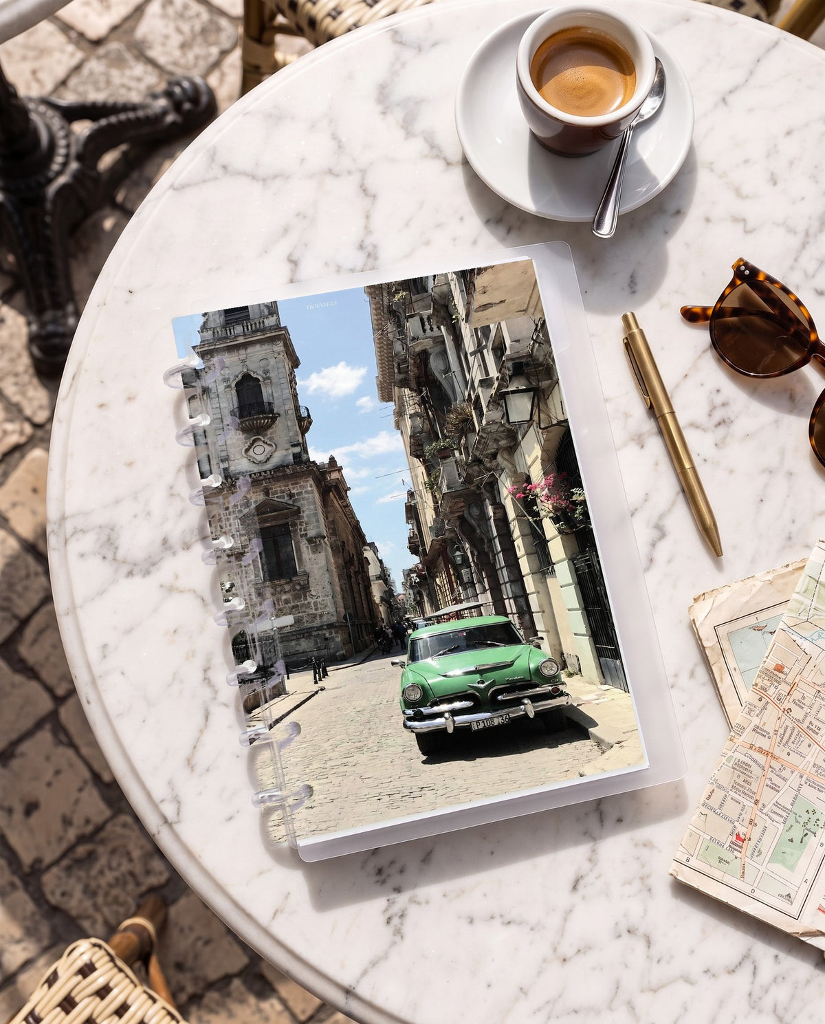 Cuba cardstock planner dashboard inside a clear half letter discbound planner with 8 discs on a marble cafe table with espresso