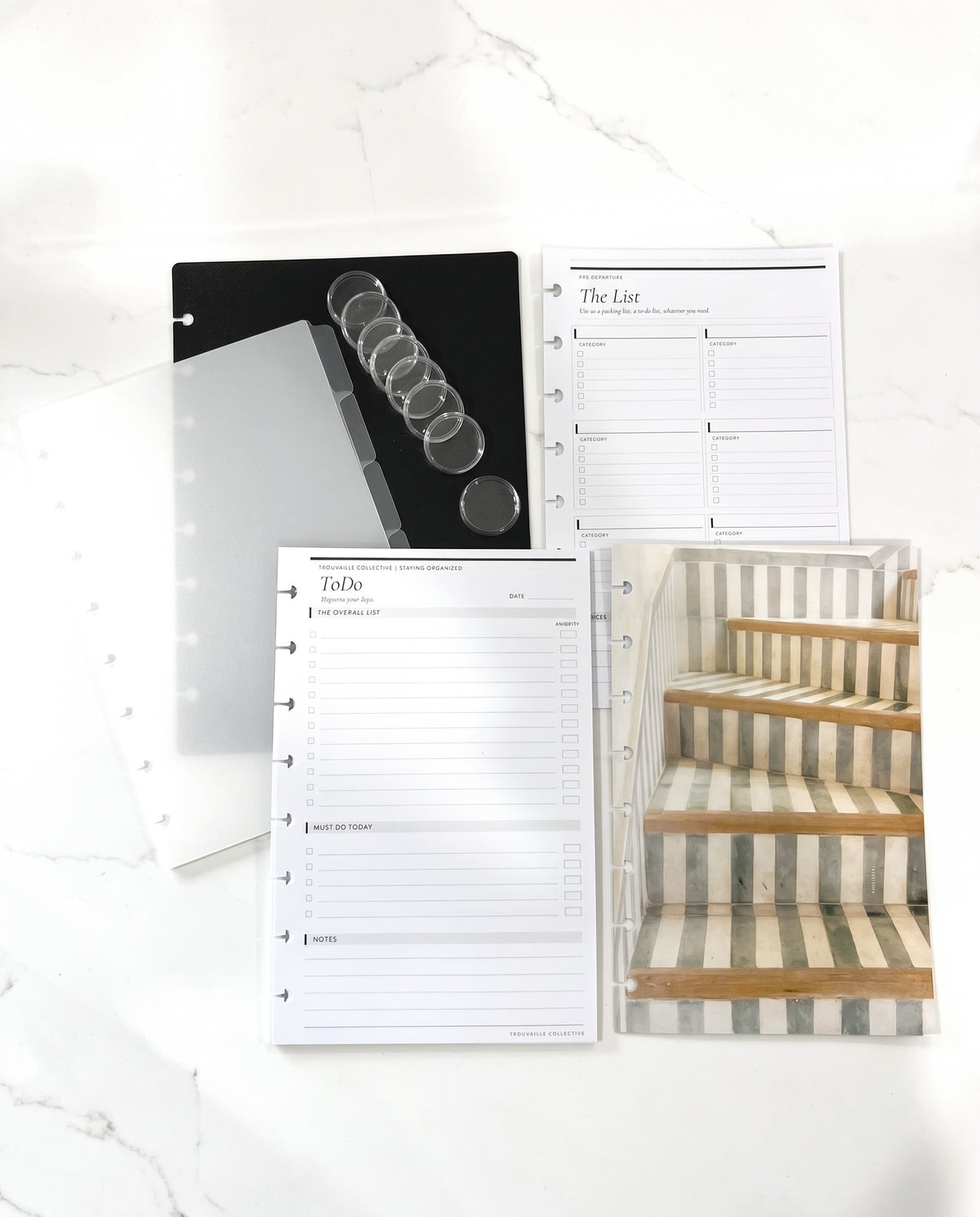 Discbound Starter Kit laid out with the Stairs dashboard, black cover, frosted dividers, 8 clear discs and To Do and The List inserts