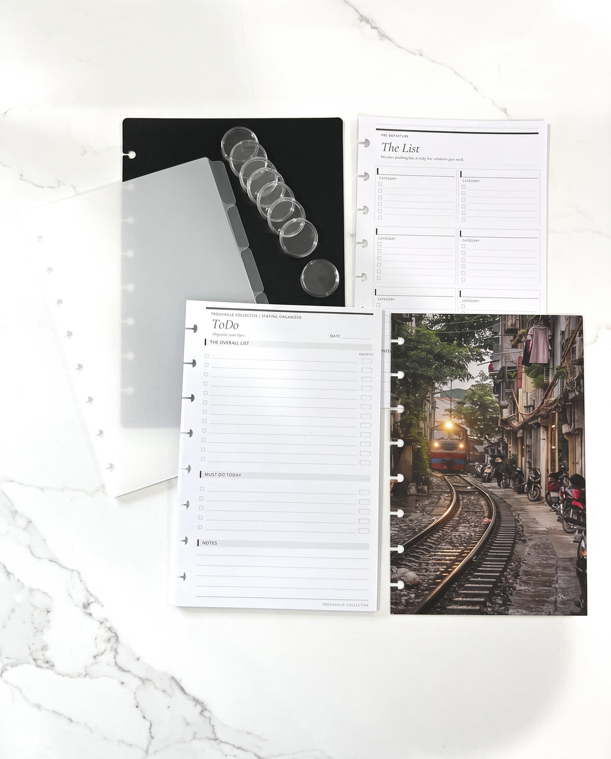 Discbound Starter Kit laid out with the Vietnam Train dashboard, black cover, frosted dividers, 8 clear discs and To Do and The List inserts