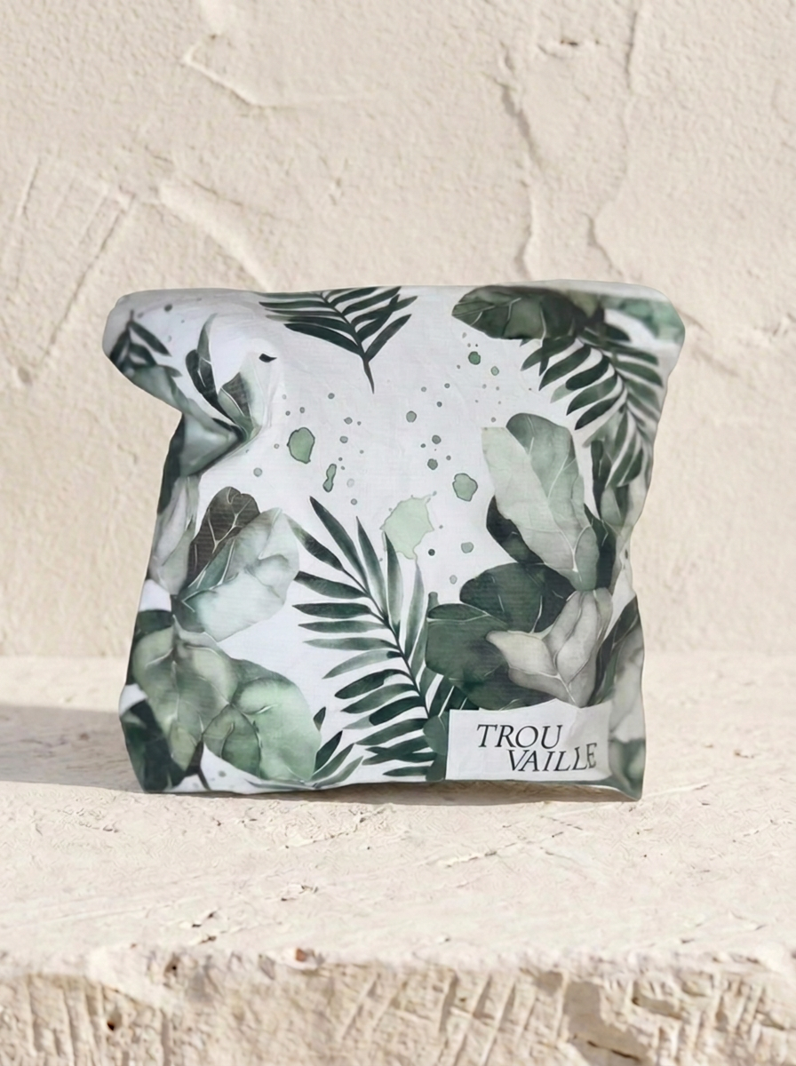 Green Leaves small water-resistant accessory bag — an 8 x 7 inch zip travel pouch in a dark green tropical leaf print