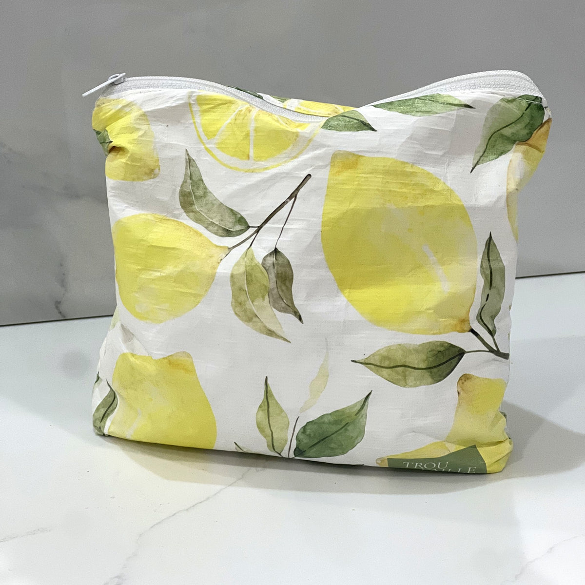 Lovely Lemons Small zip pouch on a white marble counter