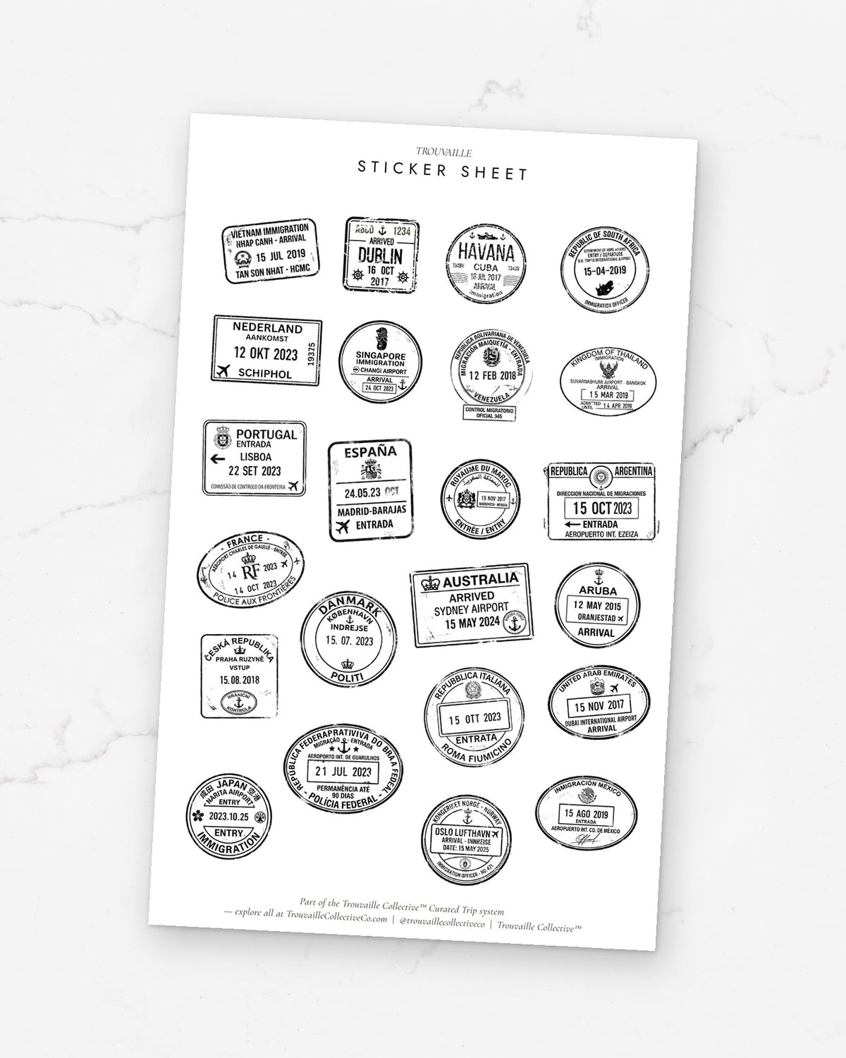 Passport Stamps clear sticker sheet on its backer card on white marble