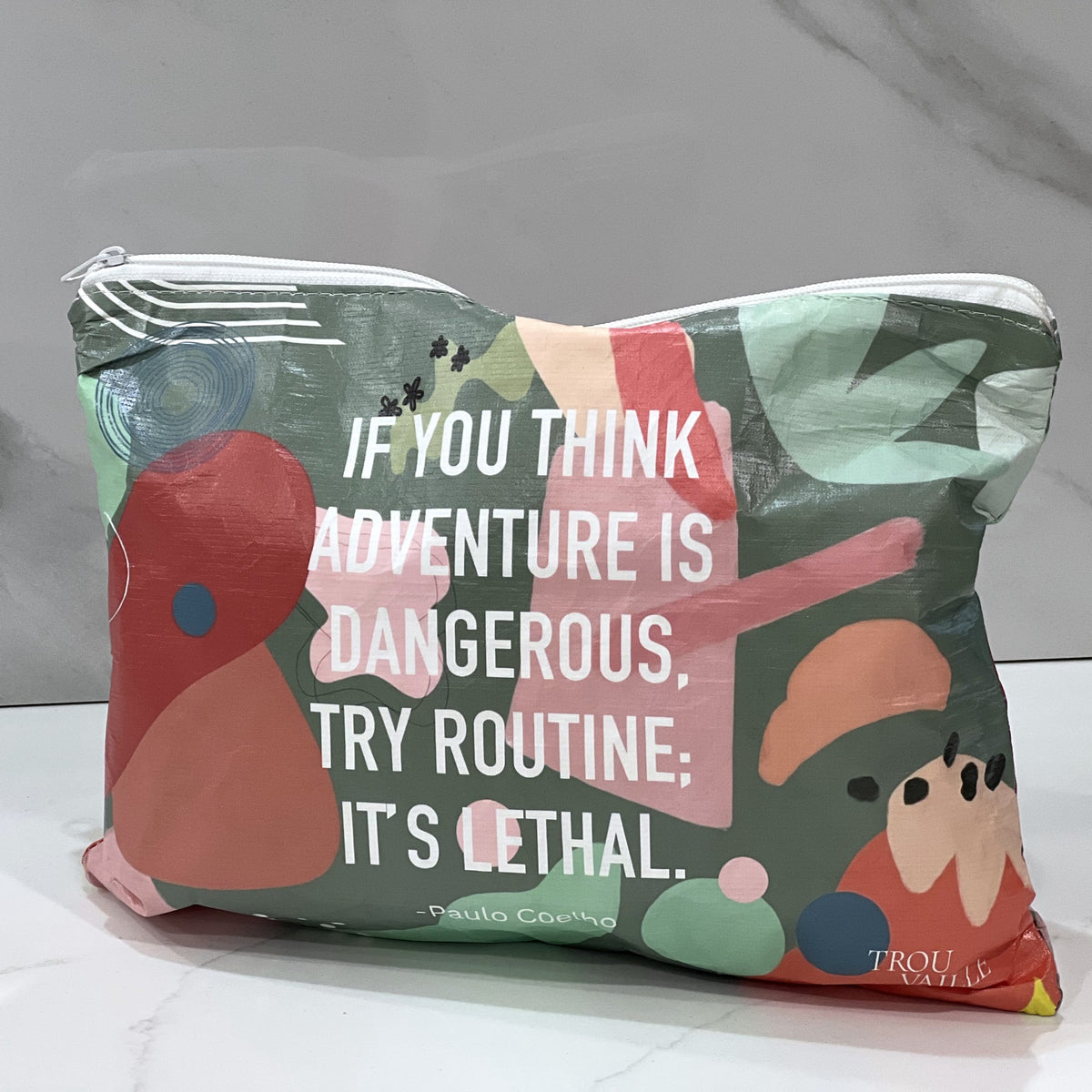 Routine is Lethal Medium flat accessory bag on a white marble counter