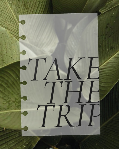 Take the Trip frosted planner dashboard on a green leaf, the leaf visible through the translucent plastic