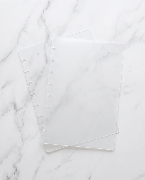 Clear frosted notebook cover set, front and back, half letter discbound covers on white marble