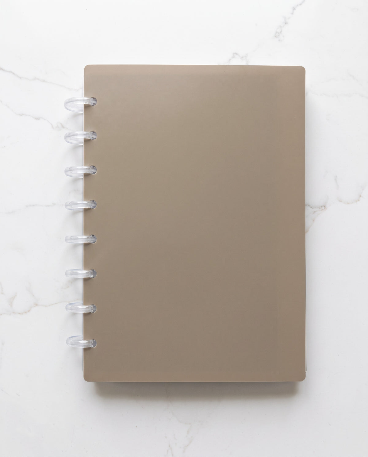 Taupe notebook cover set assembled into a discbound planner with 8 clear discs