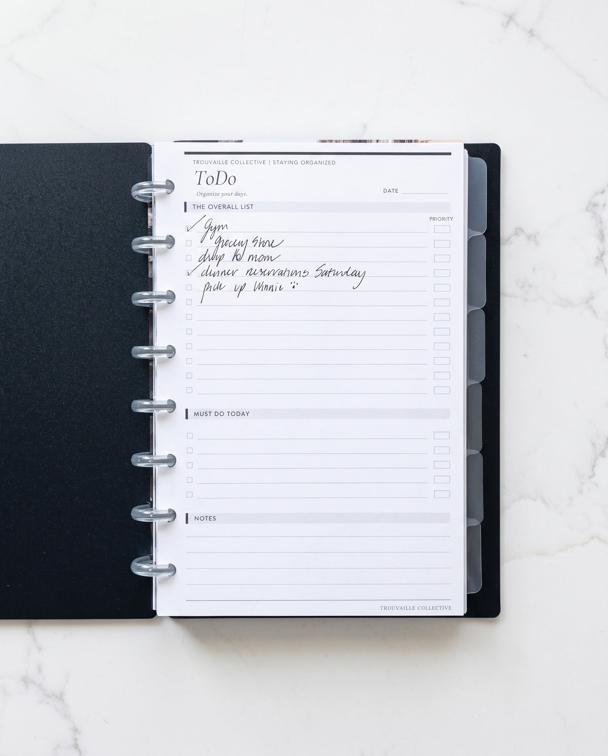 To Do planner insert with a handwritten list in a black half letter discbound planner with 8 clear discs and frosted tabbed dividers